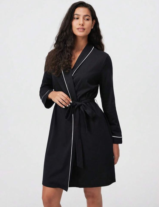La docette black robe with white piping, front view